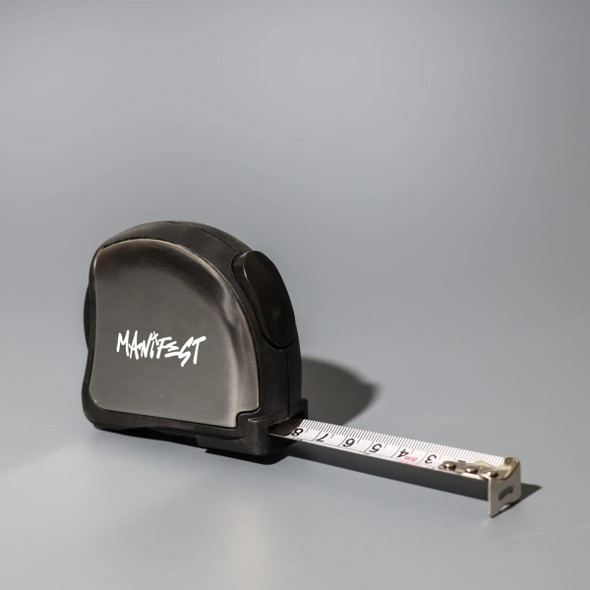A black tape measure with a retractable white measuring tape and a logo on the side.
