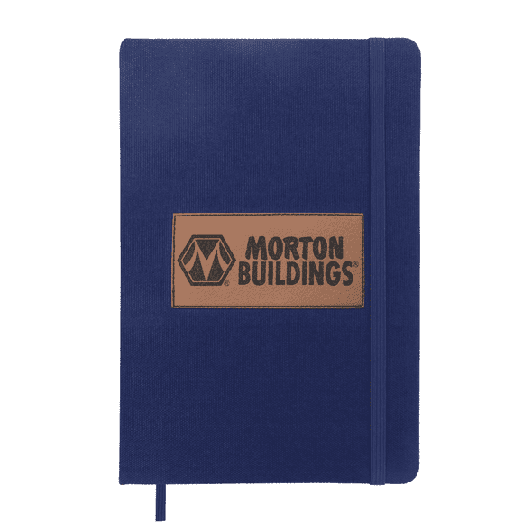A navy blue A5 notebook with a textured cover and an embossed logo patch. It includes an elastic band closure.