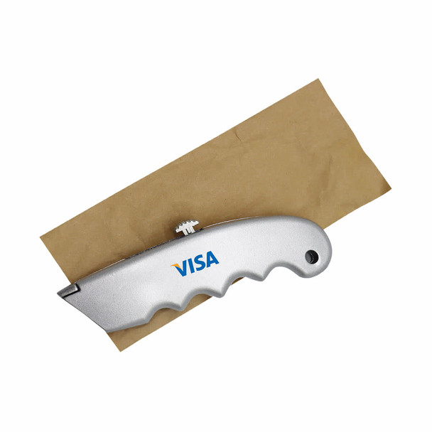 A silver cutter with a textured handle, placed on a brown paper surface. The cutter features a logo.