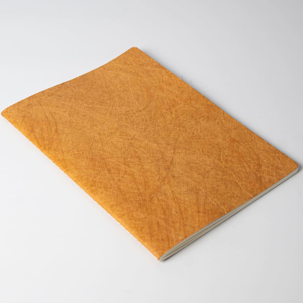 A notebook with a textured orange cover, featuring a simple design without visible branding.