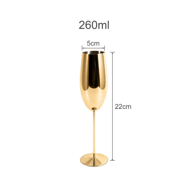 A stainless steel champagne flute in a shiny gold finish, measuring 22cm tall and 5cm wide.