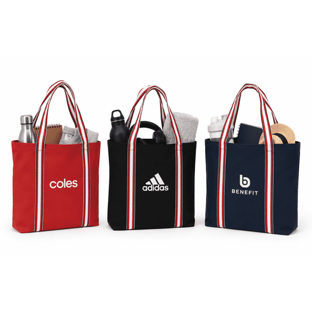 Three tote bags in red, black, and navy, each with striped handles and a logo, filled with various items.
