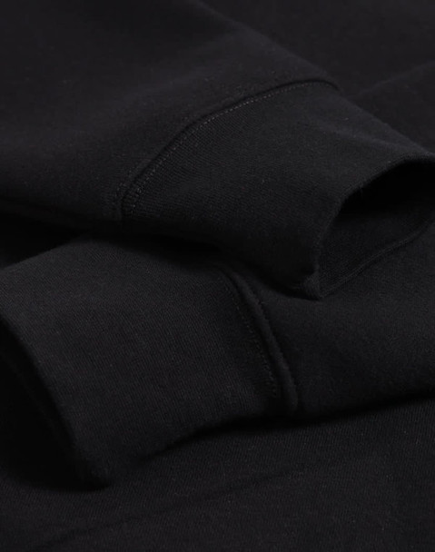 A black 1/2 zip collar fleecy jumper with visible sleeve cuffs and a subtle logo.