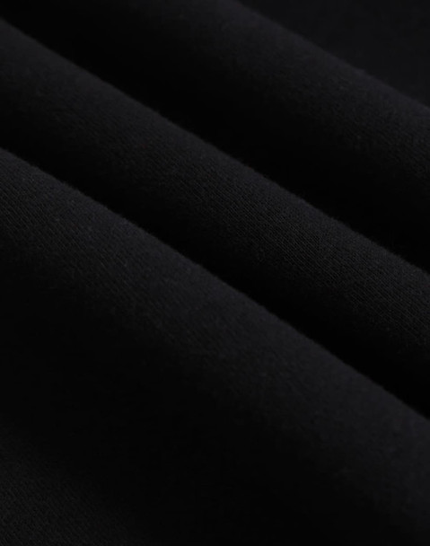 A close-up of black polar fleece fabric, showcasing its soft texture and layering. The image features a logo.