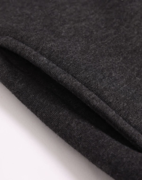 A close-up of a dark grey 1/2 zip collar fleecy jumper, showing the soft texture and stitching details.
