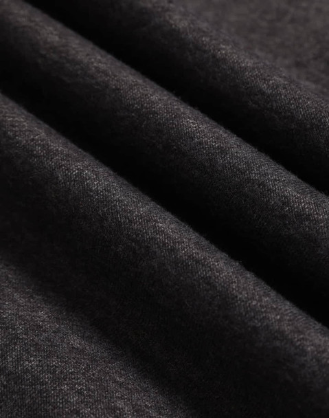 A close-up of dark grey polar fleece fabric with a soft, textured surface.