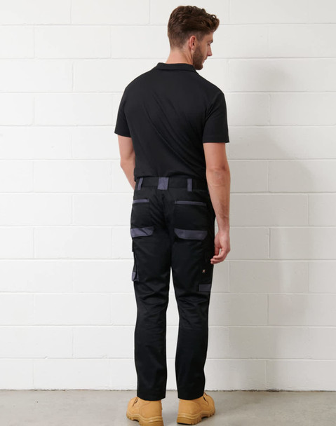 A black short-sleeve polo shirt with a logo, paired with black work pants and worn with tan boots.