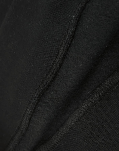A close-up view of a black crew fleece sweat, highlighting its textured fabric and stitching details.