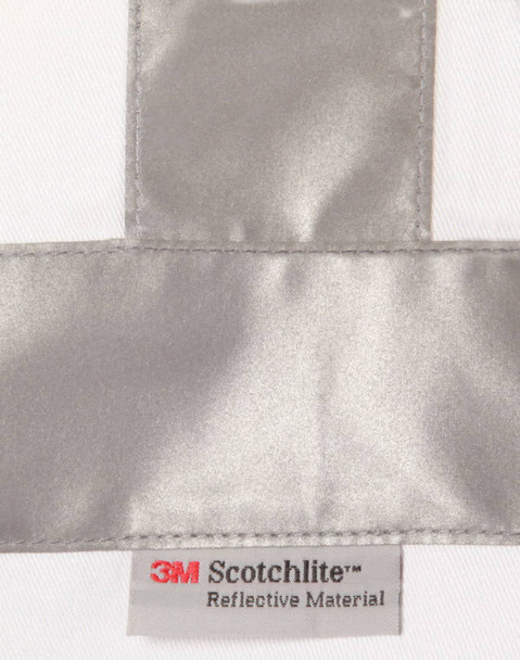 A reflective silver strip on a white fabric with a label for 3M Scotchlite reflective material.
