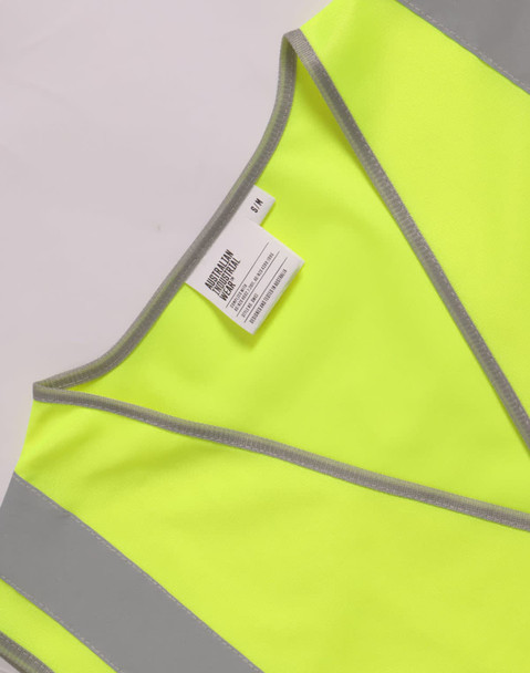 A bright yellow safety vest featuring reflective shoulder tapes and a label.
