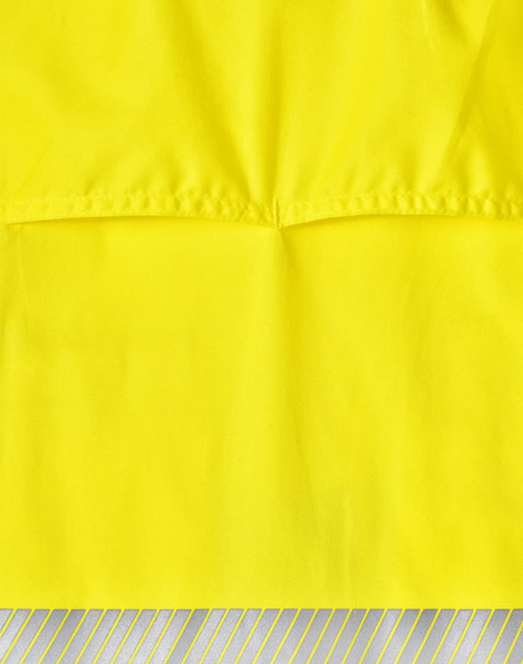 A bright yellow long-sleeve safety shirt featuring segmented reflective tape at the bottom. It includes a logo.