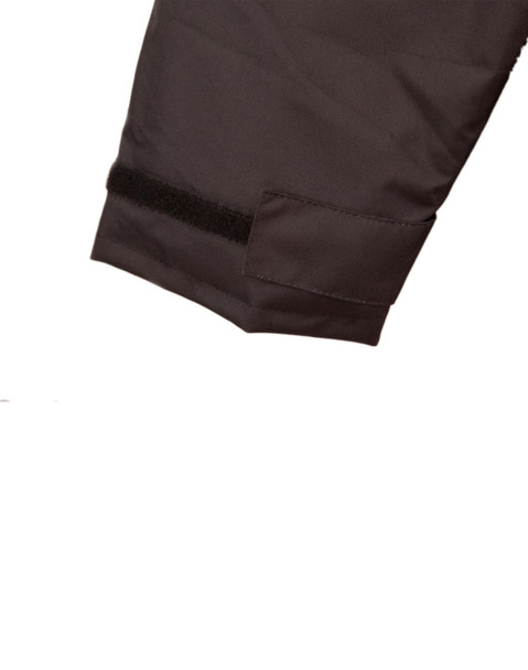 A close-up of a dark-coloured quilted safety jacket featuring a velcro strap on the sleeve.