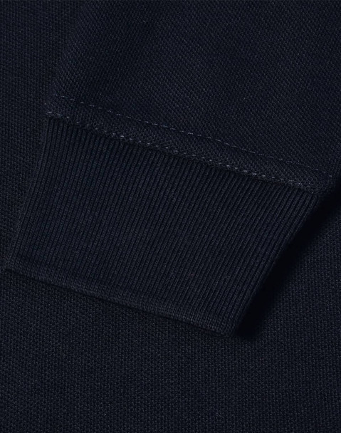 A close-up view of the cuff of a navy blue polo shirt featuring a ribbed design and a logo.