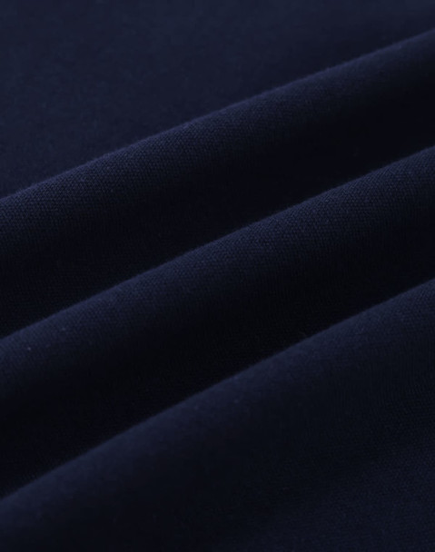 A close-up of navy cotton fabric with visible stretch and texture, ideal for polo shirts.