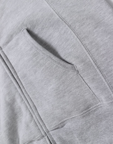 A grey ladies' full-zip fleecy hoodie featuring a front pocket and soft fabric texture. The hoodie has a branding logo.