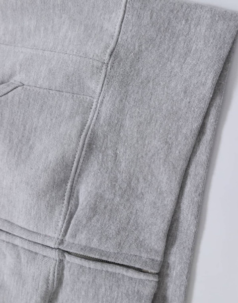 A grey full-zip fleecy hoodie featuring a pocket and a logo. Ideal for casual wear.