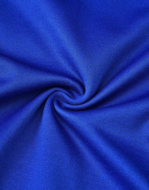A close-up of smooth, vibrant royal blue fabric with a subtle texture, ideal for polo shirts.