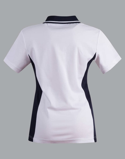 A ladies' polo shirt in white with navy contrast accents, featuring a collar and short sleeves. It has a logo detail.