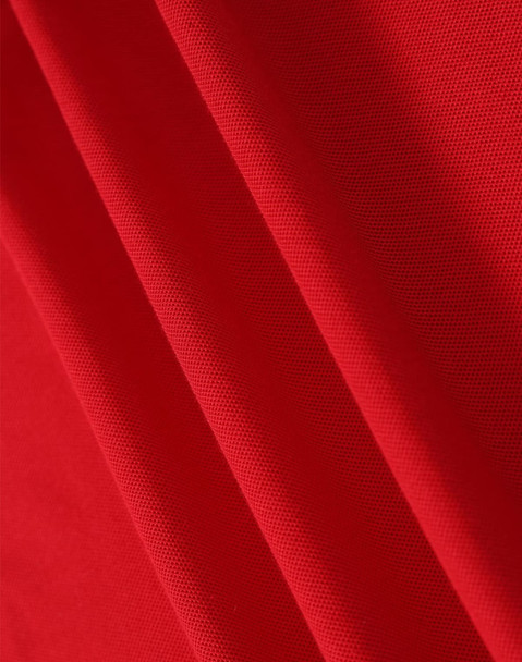 A red fabric with a textured surface, showcasing the material of a polo shirt. It has a logo in the corner.