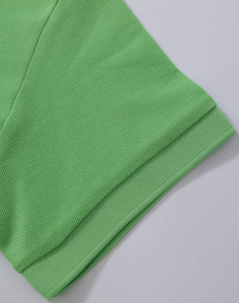 A vibrant green Ladies' Truedry Pique Polo showcasing the sleeve and hem details. Features a logo.