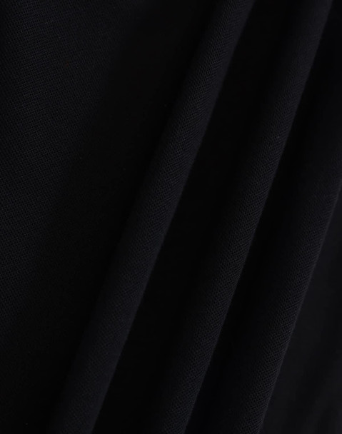 A close-up of a black fabric with a textured surface, featuring folds and draping. The image showcases the material's quality.