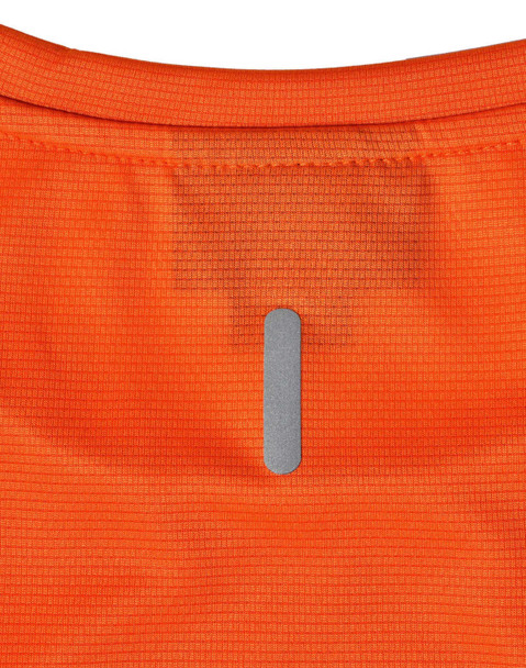 An orange ladies’ lightweight performance T-shirt featuring a logo on the back.