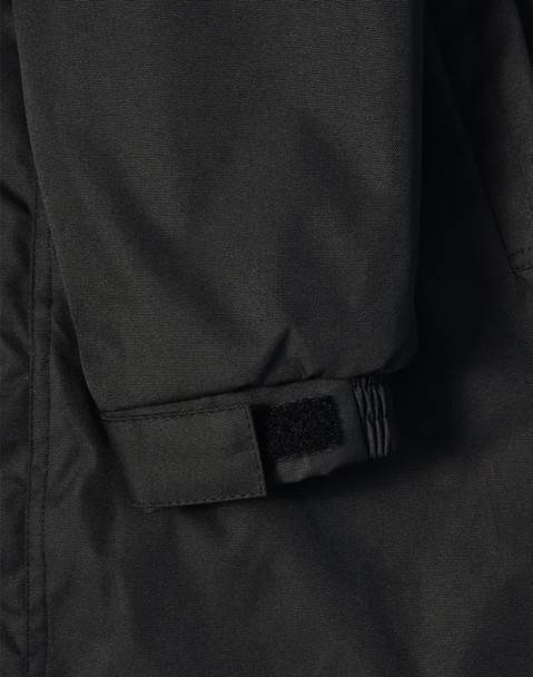 A close-up of a black long line stadium jacket featuring adjustable wrist cuffs and a logo.