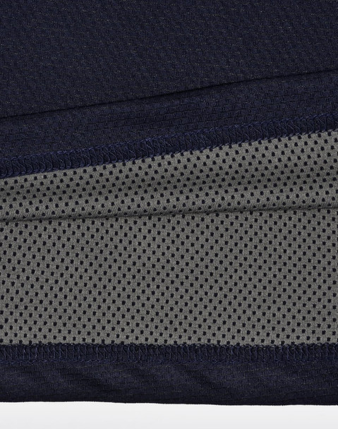A close-up of a navy and charcoal polo shirt, featuring a textured fabric and a logo.