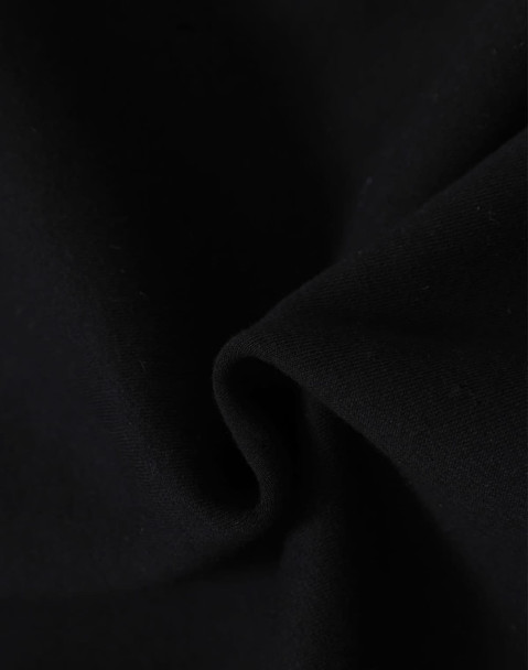A close-up of black fabric, showcasing a soft, fleecy texture. The material is ideal for apparel like hoodies.