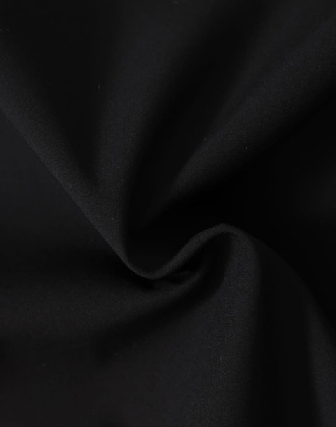 A close-up of black fabric featuring a soft texture, ideal for softshell jackets.