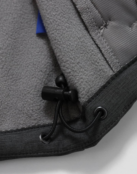 A close-up of the interior of a grey men's softshell full zip hoodie, featuring a drawstring and soft fabric lining.