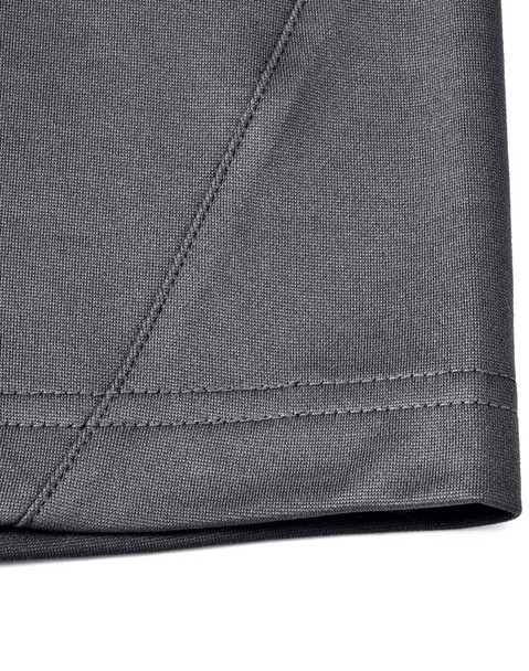 A close-up of the hem and stitching of a grey polo shirt made from sustainable poly/cotton fabric.