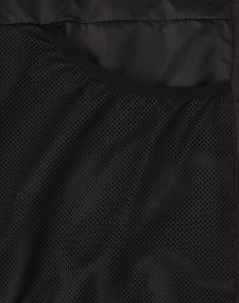 A close-up of a black puffer jacket's inner mesh lining, featuring a pocket and textured fabric.