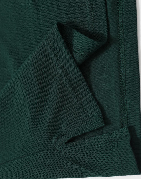 A dark green men's polo shirt featuring a folded hem and stitching details, including a logo.