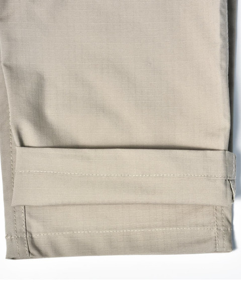 A pair of light khaki Rip-Stop poly/cotton stretch work pants with a cuffed hem. Features a logo.