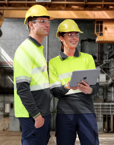 A unisex long-sleeve safety polo in high-visibility yellow with grey segments, featuring two workers wearing hard hats and safety glasses.