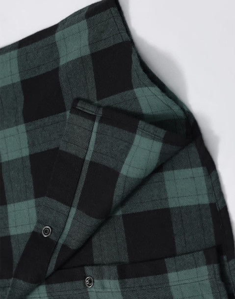 A unisex flannel plaid shirt featuring green and black checks, with buttons and a small pocket detail.