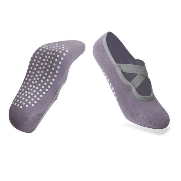 A pair of grey yoga socks featuring a non-slip dotted sole and a crisscross strap design.