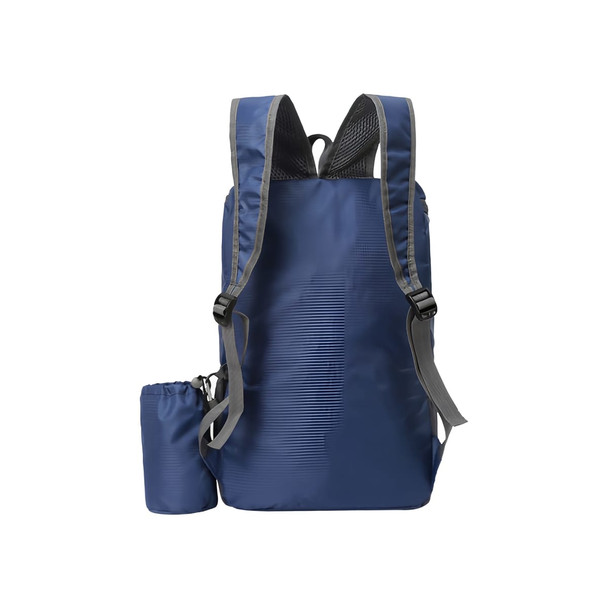 A navy blue packable travel backpack with grey straps and a compact pouch attached. Features a logo.
