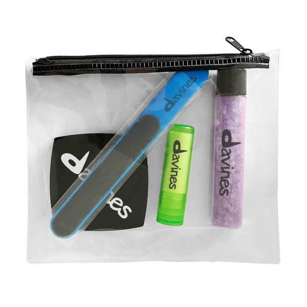 A clear zippered pouch containing a nail file, lip balm, and a tube of bath salts, featuring branding throughout.