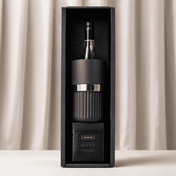 A black gift box containing a wine bottle and a glass, with a branded logo on the packaging.