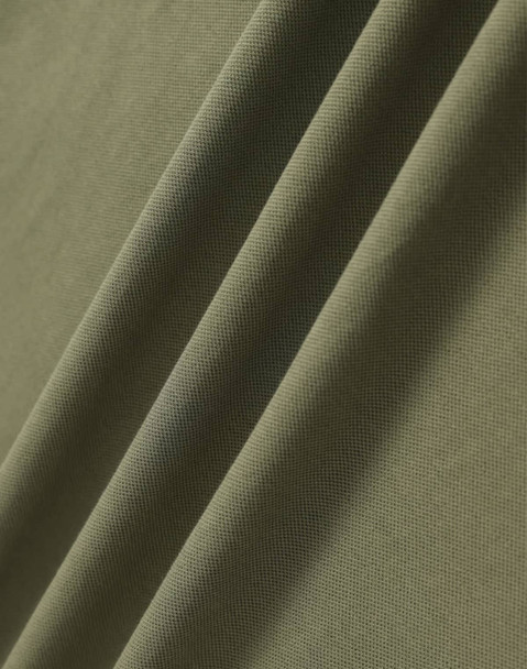 A close-up of a textured, ultrafine cotton pique fabric in olive green, featuring subtle folds.