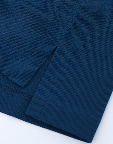 A close-up of a navy blue men's ultrafine cotton pique polo, highlighting the fabric texture and hem details.