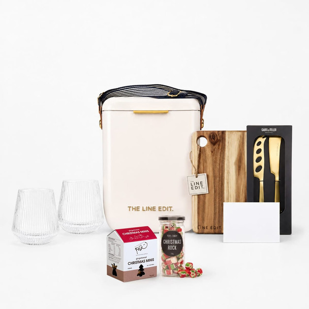 A cream insulated bag, two clear glasses, a wooden cutting board, a knife, a Christmas treat box, and a card.