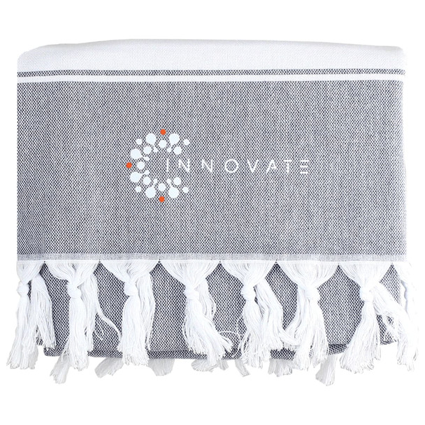 A grey towel with white fringe detailing and a logo printed on it.