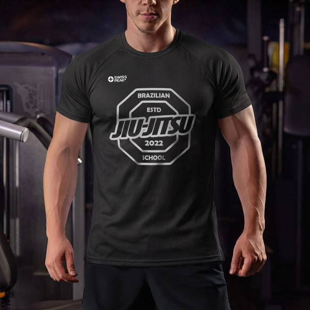A black unisex t-shirt featuring a circular logo with the words "Brazilian Jiu-Jitsu School" prominently displayed.
