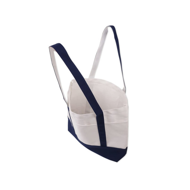 A medium canvas tote bag featuring a white body and navy blue accents, with adjustable straps and a logo.