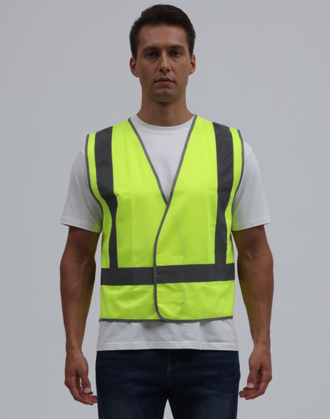 A bright yellow safety vest featuring reflective strips, worn by a model against a plain background.
