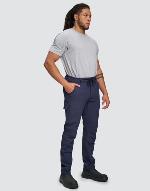 Flexi work pants in navy blue worn by a person standing, paired with a grey t-shirt and black shoes.