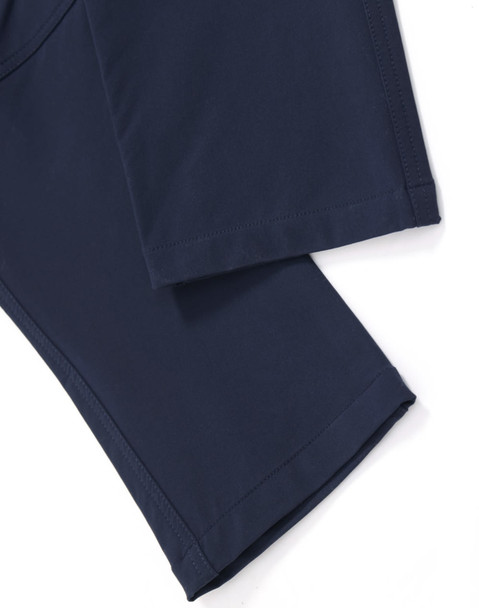 Navy flexi work pants featuring a smooth, lightweight fabric with clean hems and an integrated logo.